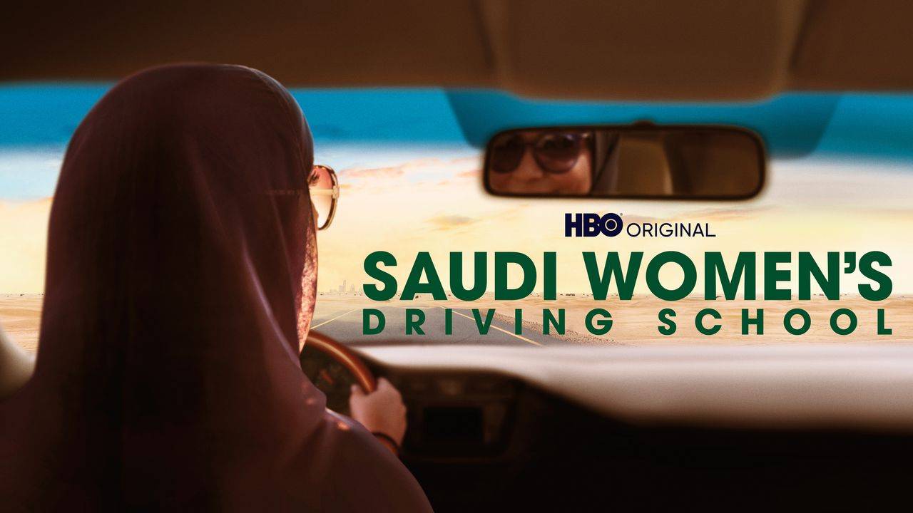 A Muslim woman driver looking in the rearview mirror in this image from HBO Max 