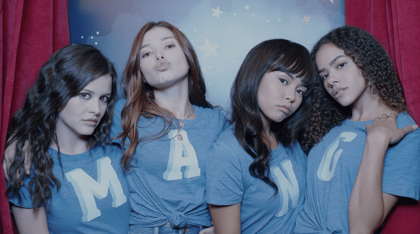 Four girls pose in a photo booth in this image from Netflix