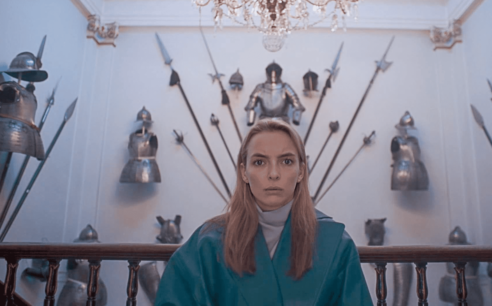 A woman in a room with suits of armor in this image from Hulu 