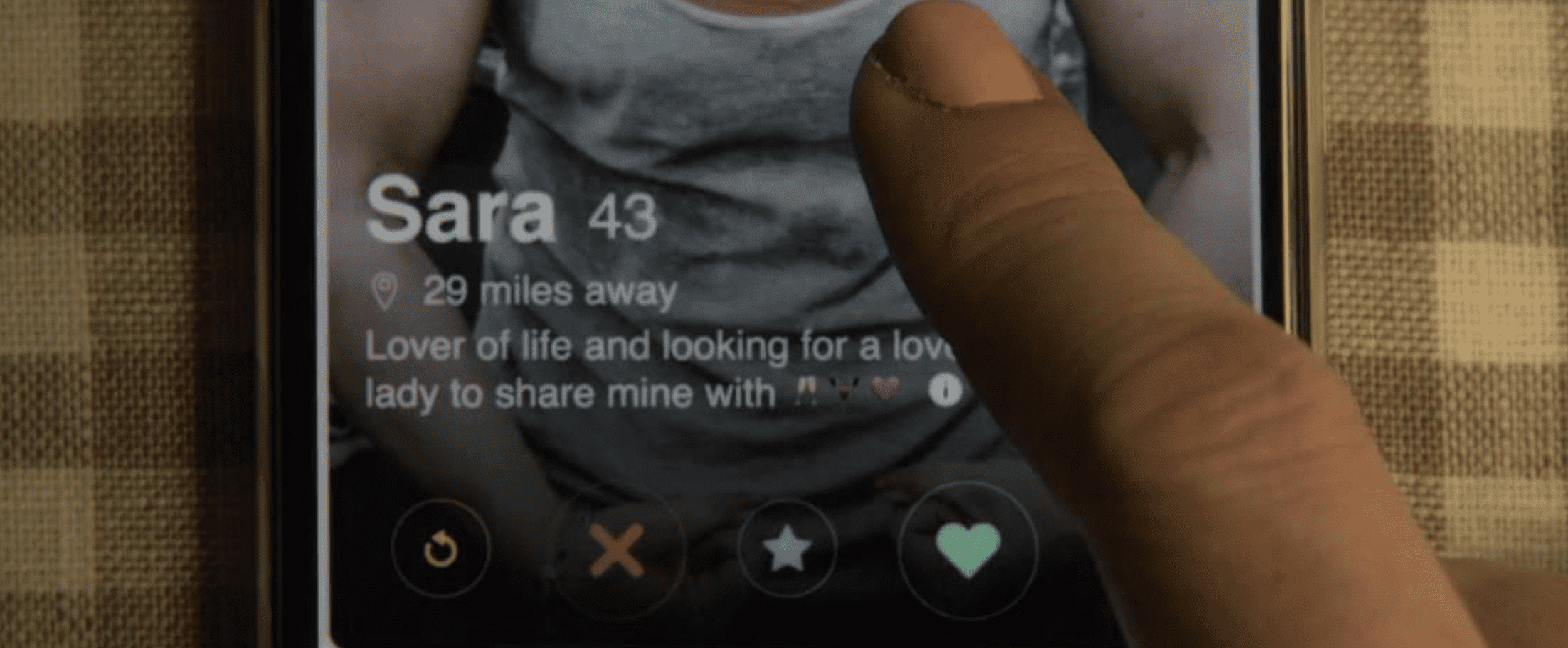 A finger hovers over a dating app in this image from Netflix